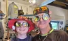 Two individuals are smiling for the camera while wearing whimsical goggles and hats inside a store.
