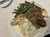 The image depicts a plate containing a serving of green beans, mashed potatoes, and shredded meat, possibly roasted or braised, with some gravy or sauce.