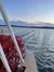 A sunset view over a lake with a paddle wheel boat in the foreground.