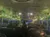 The image shows the interior of a bus with passengers seated, decorated with hanging license plates and string lights along the windows.