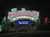 The image shows a brightly lit sign for the Showboat Branson Belle, surrounded by colorful lights and decorated trees.