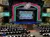 The image shows a colorful theater stage set for a