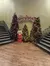 The image shows a festive lobby with Christmas trees, a nutcracker decoration, and a sign for