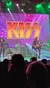 A band performs on stage in front of a large