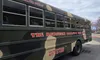 A camouflage-painted bus featuring
