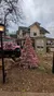 A pink-themed display features a pink Jeep adorned with a wreath, a pink Christmas tree, and a sign for