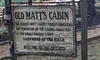 The image shows a wooden sign for
