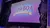 The image shows a stage with a backdrop displaying