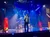 A person is performing on a colorful, illuminated stage with dynamic lighting effects.