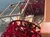 The image shows a red paddle wheel of a steamboat rotating in the water.