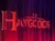The image shows a dimly lit stage curtain with the words