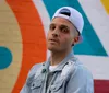 The image features a smiling person wearing a cap and jacket with text announcing them as the winner of Americas Got Talent and their name is Dustin Tavella