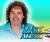 A person in a sparkling blue shirt is featured on a colorful background advertising Music from the 70s 80s 90s with the phrase Jukebox Live