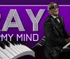 The image shows a person playing the piano with the text RAY ON MY MIND against a purple backdrop featuring stylized piano keys