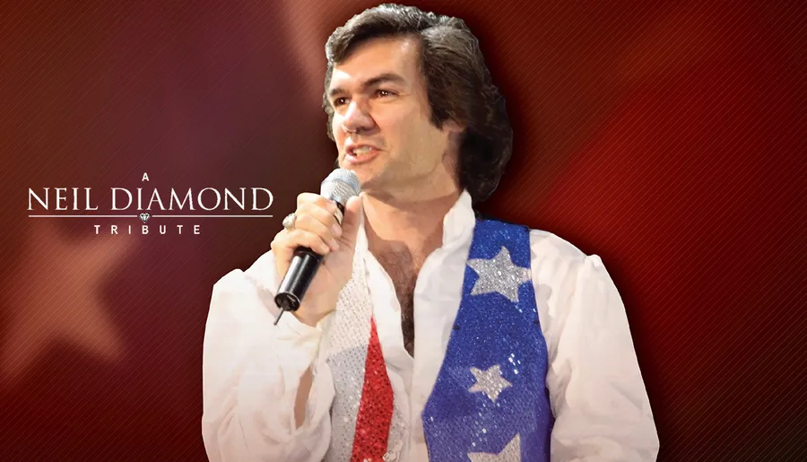A performer in a red, white, and blue sequined vest is singing into a microphone, with a backdrop that reads A Neil Diamond Tribute.