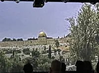 The image shows a view of the Dome of the Rock, a prominent gold-domed structure, surrounded by trees and stone buildings.
